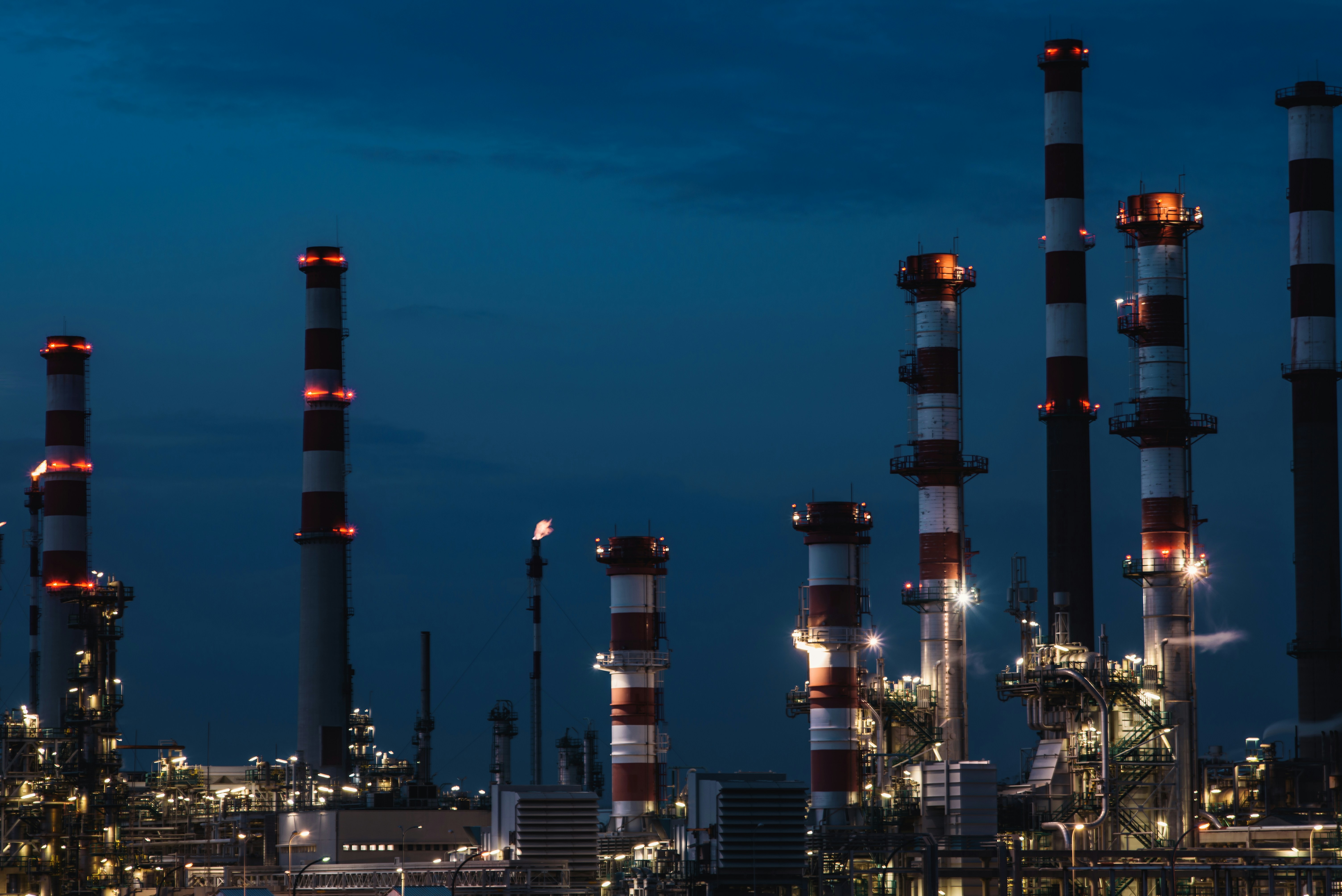 Industrial facility with illuminated stacks at night