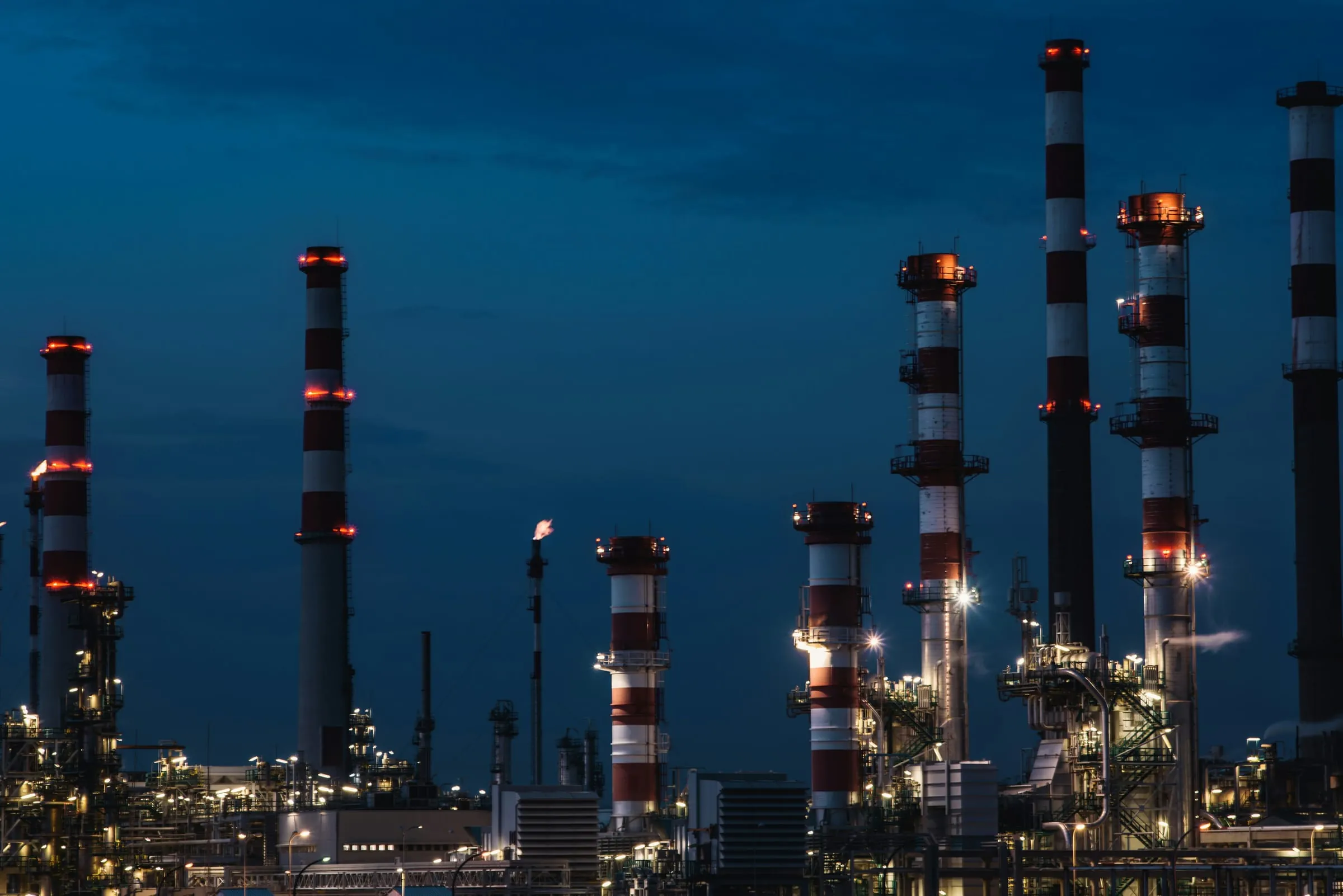 Industrial facility with illuminated stacks at night