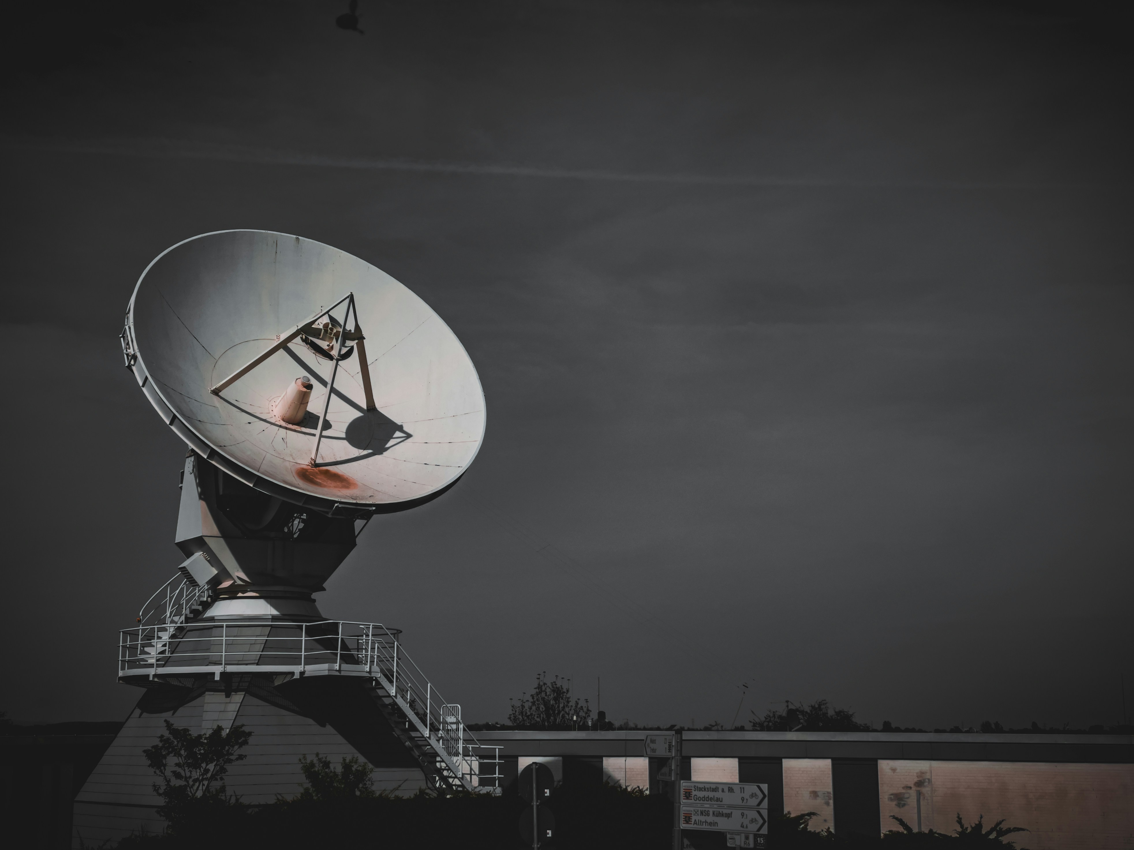 Large satellite dish against a dark sky