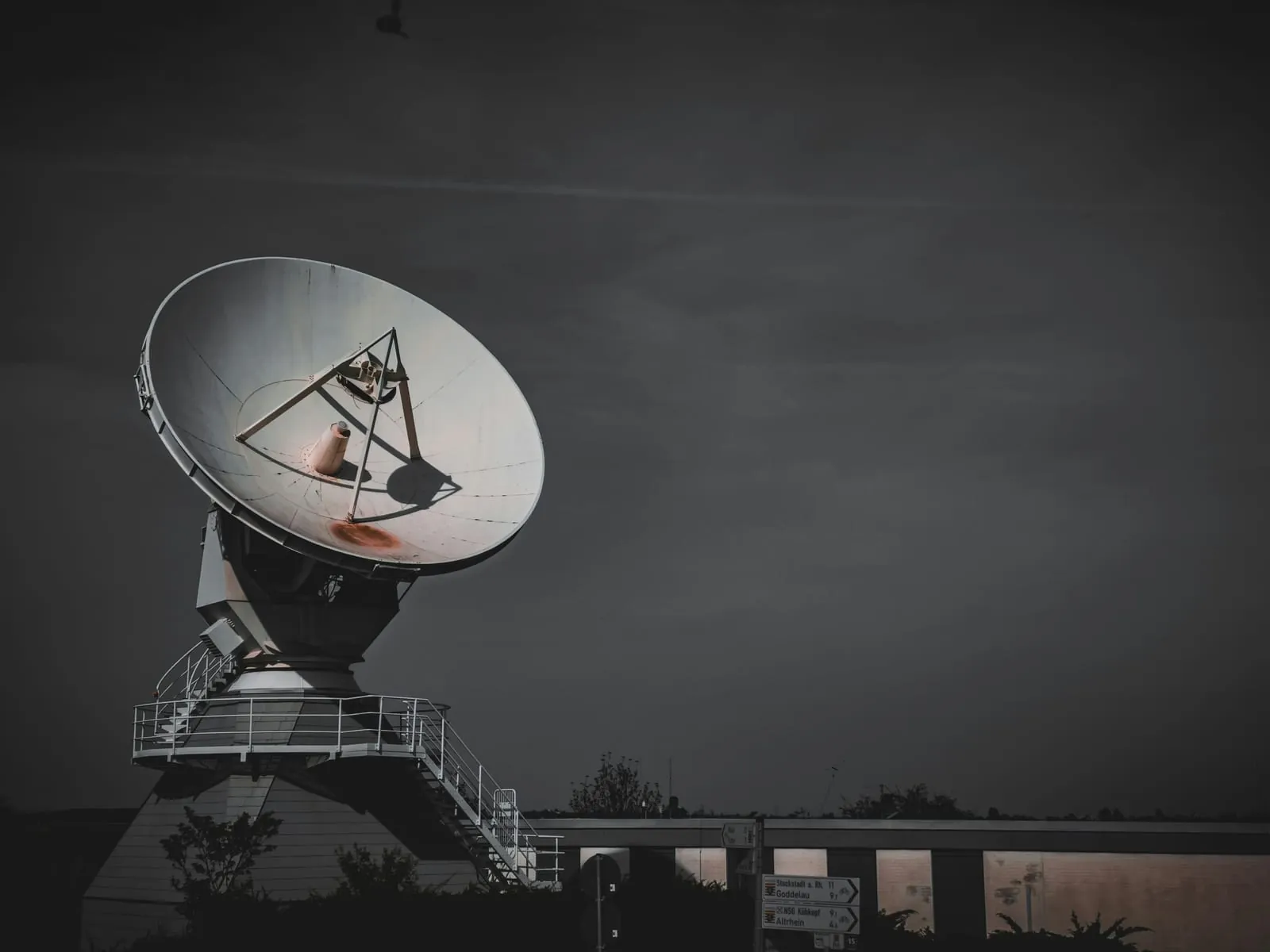 Large satellite dish against a dark sky